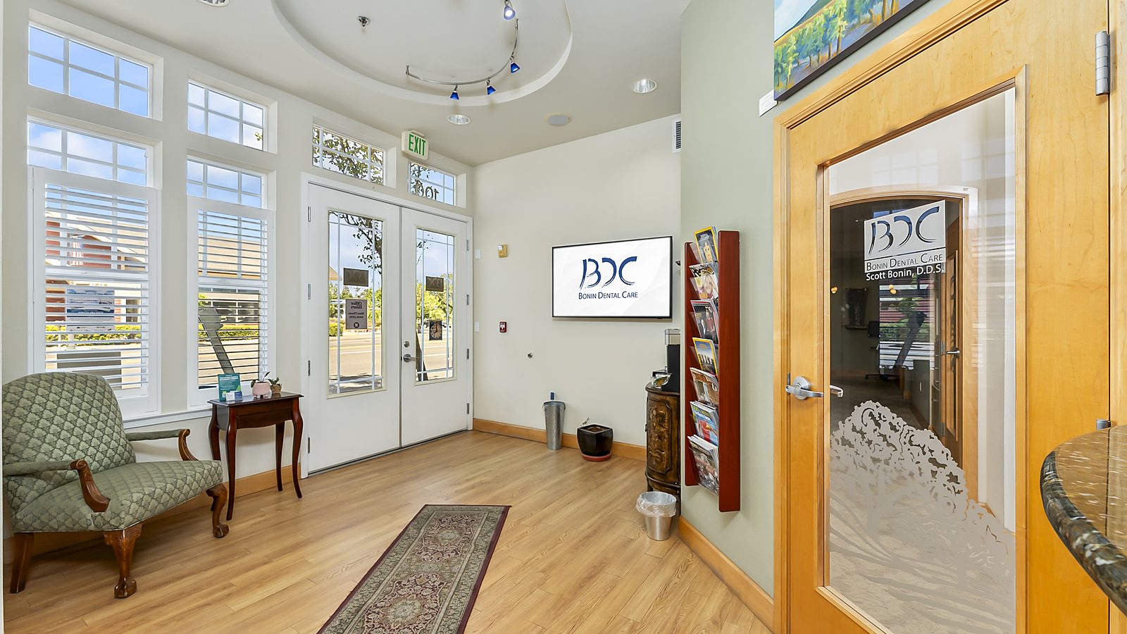 Bonin Dental Care logo on the glass entry door at the Windsor office